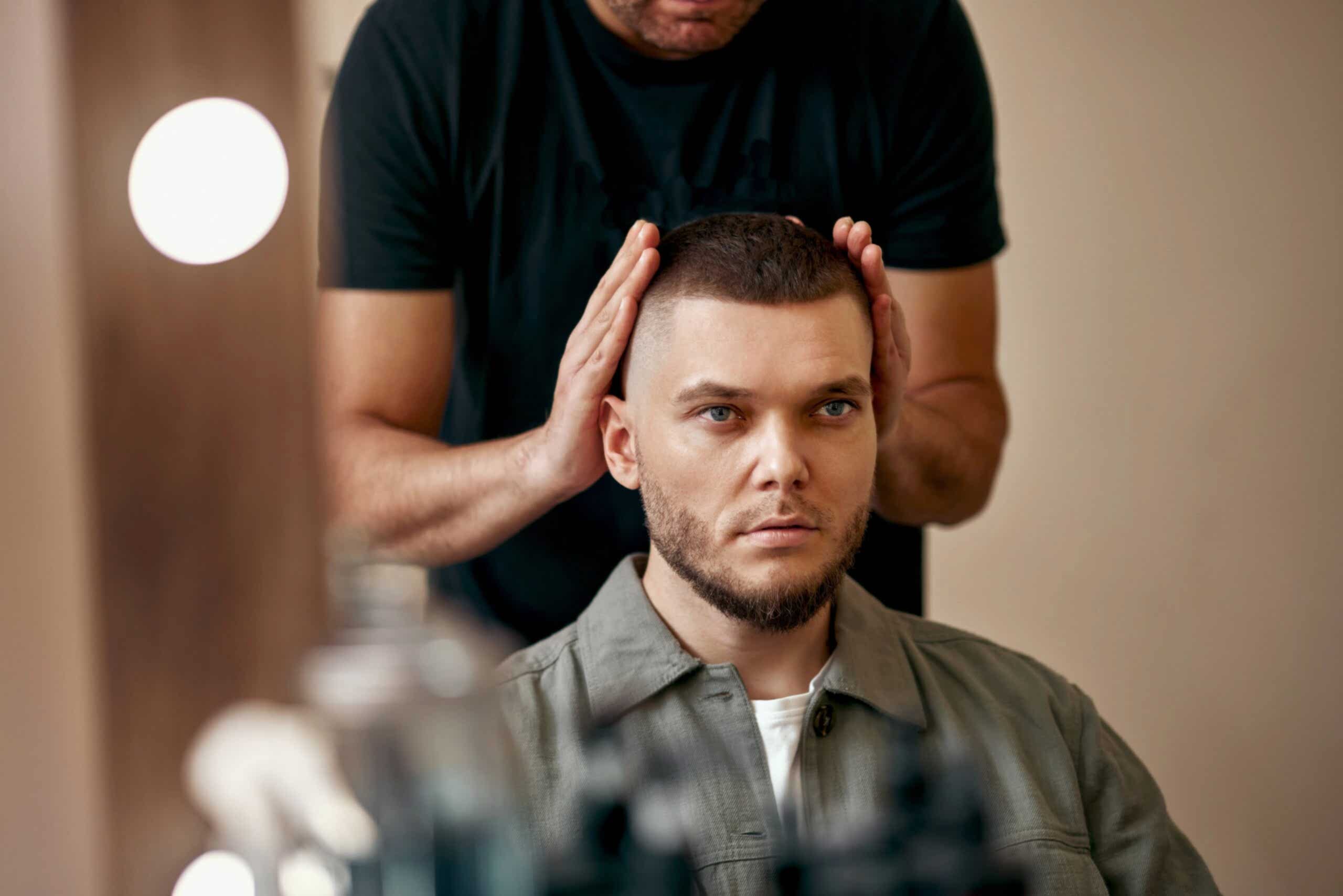 Man receiving high and tight haircut at barbershop