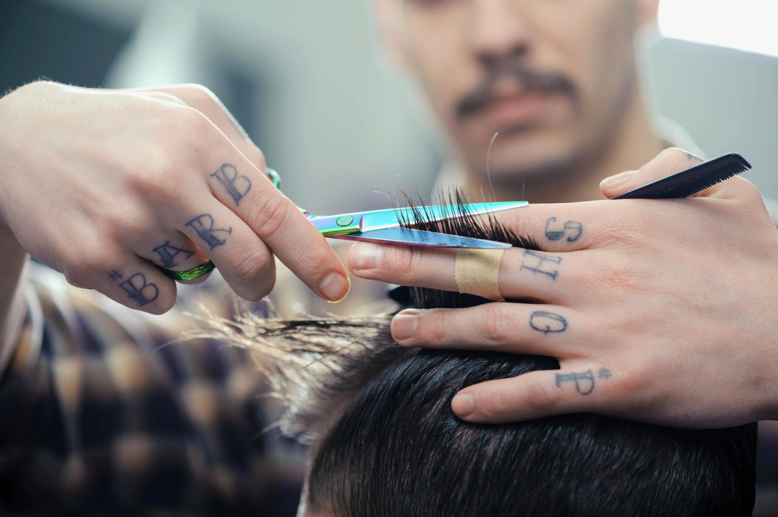 Close-up of barber trimming hair