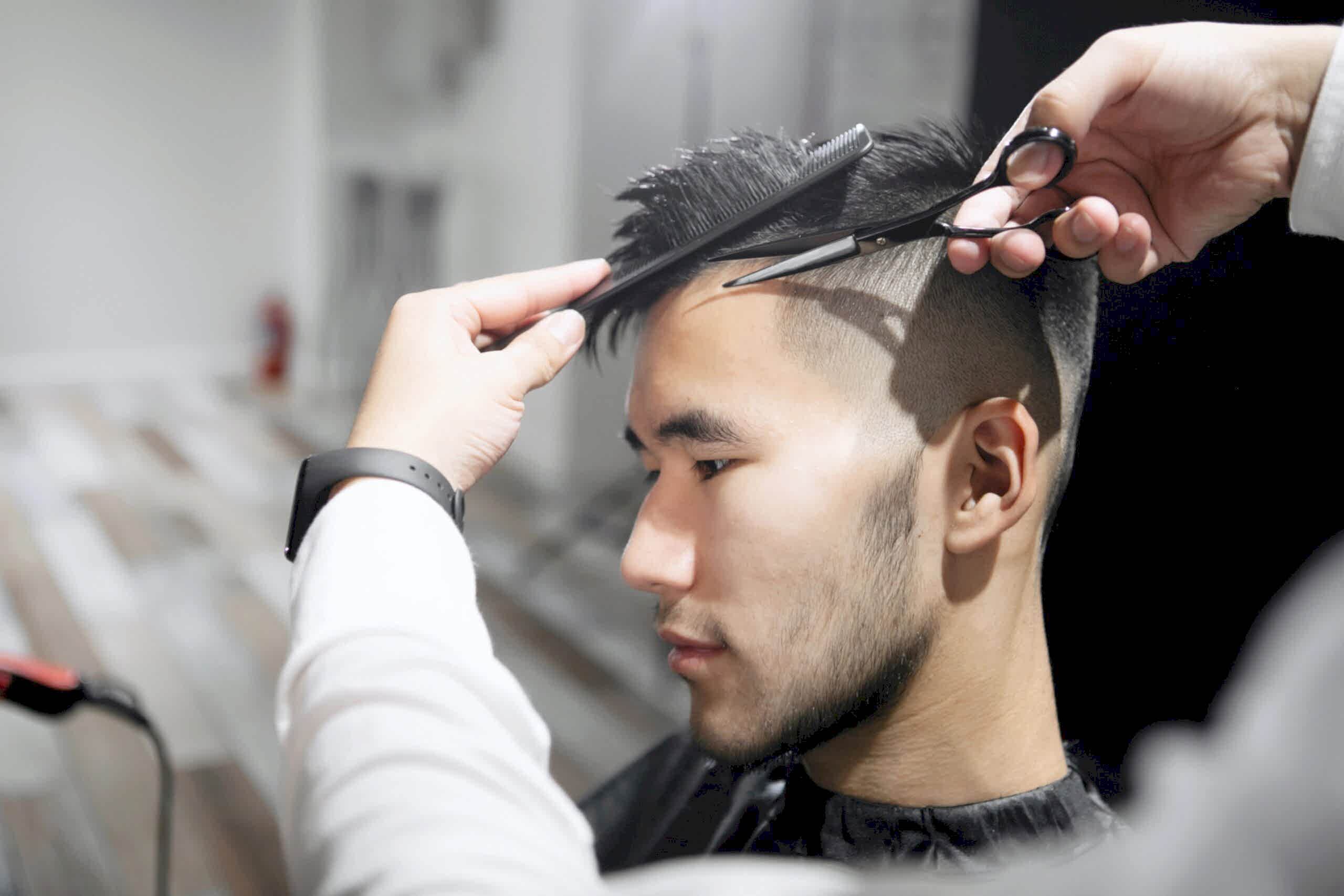 Young man receiving haircut